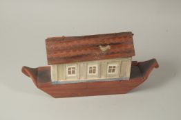 AN EARLY PAINTED WOODEN NOAH'S ARK with lots of carved wood animals. 15ins long x 7.5ins high.