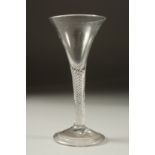 A GEORGIAN WINE GLASS with air twist stem and tapering bowl. 6ins high.