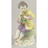 A MEISSEN PORCELAIN FIGURE OF A BOY in a yellow coat and carrying a garland of flowers. 4.5ins high.