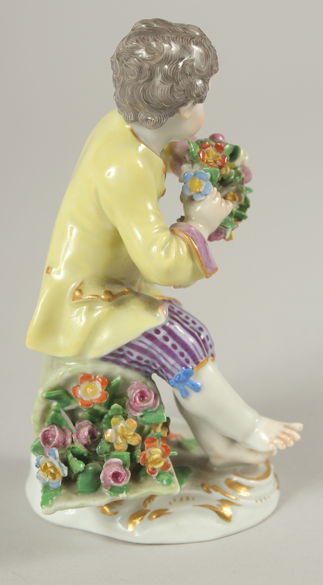 A MEISSEN PORCELAIN FIGURE OF A BOY in a yellow coat and carrying a garland of flowers. 4.5ins high. - Image 2 of 4