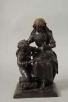 A BRONZE GROUP OF MOTHER AND CHILD. 38cms high.