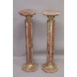 A PAIR OF RED MARBLE CLUSTER COLUMNS with gilt metal mounts. 3ft 4ins high.