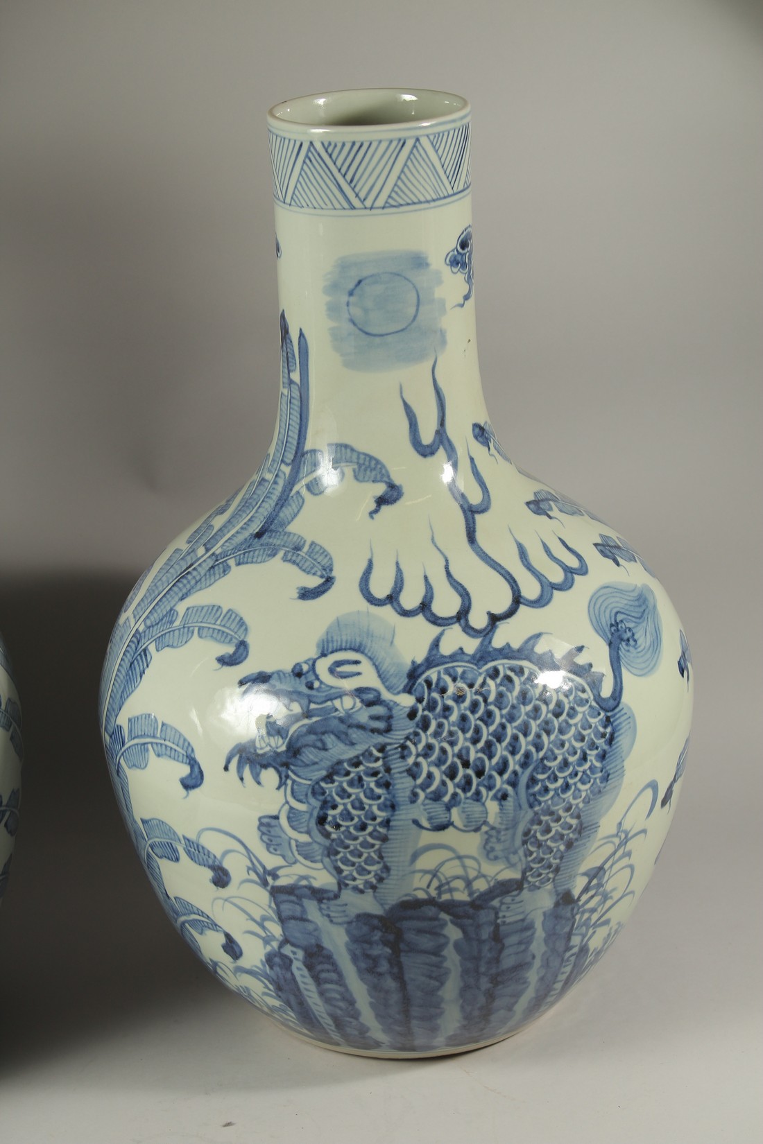 A LARGE PAIR OF CHINESE BLUE AND WHITE BULBOUS VASES decorated with dragons. 60cms high. - Image 3 of 4