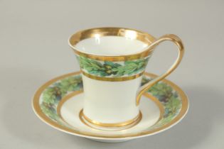 A BERLIN CUP AND SAUCER with oak decoration. Circa. 1845. Cup: 9cm, saucer 14.4cm diameter.