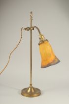 A BRASS LAMP with a MULLER FRES SHADE.