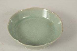 A CHINESE CELADON GLAZE PETAL FORM DISH. 14.5cms diameter.