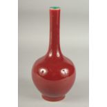 A CHINESE OXBLOOD GLAZE PORCELAIN BOTTLE VASE, the base with character mark. 26cm high.