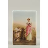 A CONTINENTAL PORCELAIN PLAQUE, a young lady reading a book, a cupid standing by a fence. 14cms x