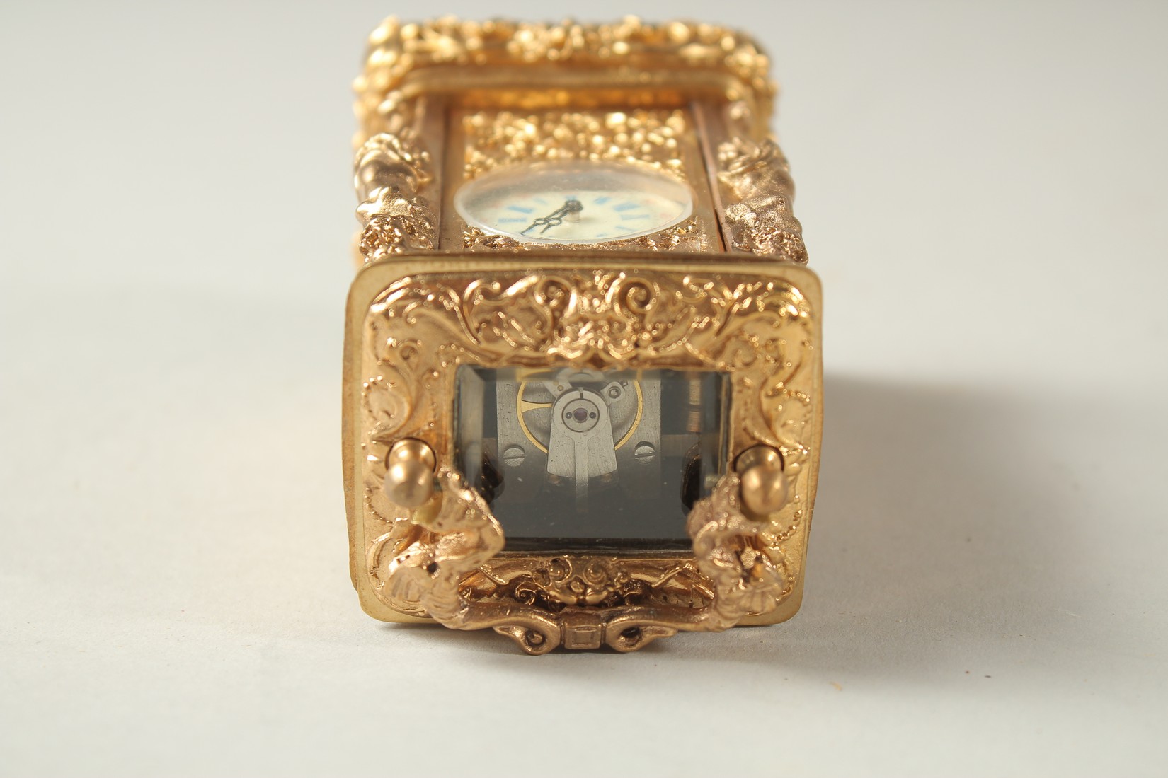 A CAST GILT MINIATURE CARRIAGE CLOCK with female figures. - Image 5 of 5