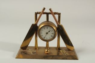 A NOVELTY CRICKET CLOCK formed as a ball, two bats, a stump and gloves. 9ins long x 7ins high.