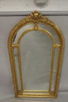 A GOOD LARGE GILT FRAMED VICTORIAN STYLE ARCH TOP MIRROR. 7ft 4ins x 3ft 8ins wide.