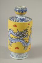 A CHINESE PORCELAIN YELLOW GROUND VASE decorated with dragons. 21cms high.