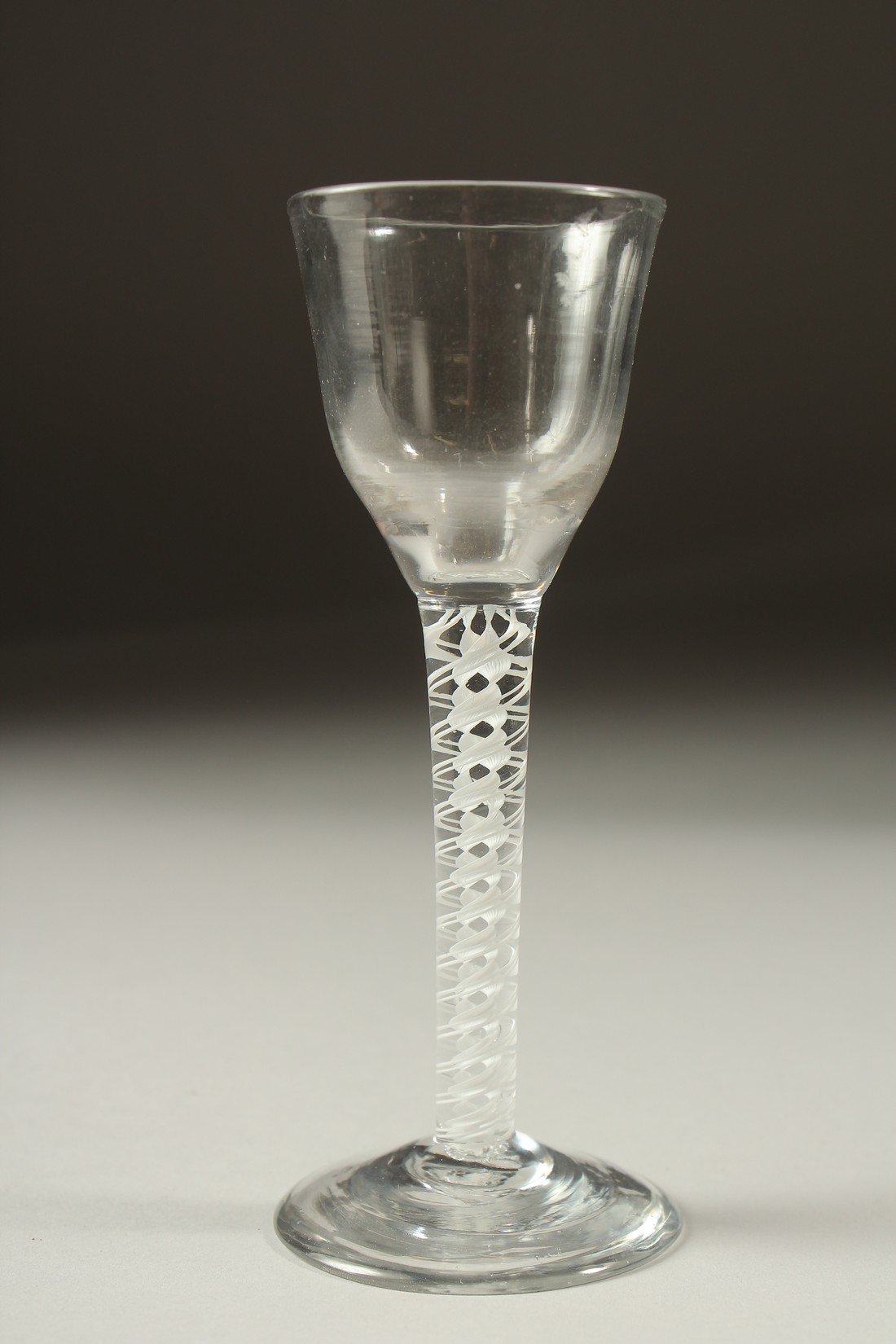 A GEORGIAN WINE GLASS with white opaque stem. 5.5ins high.