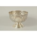 A VICTORIAN CIRCULAR ROSE BOWL with repousse decoration. 6ins diameter. Chester 1897.