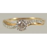 A 9CT YELLOW GOLD SOLITAIRE-STYLE RING SET WITH 0.22 RBC DIAMONDS IN TOTAL, in a twist-style