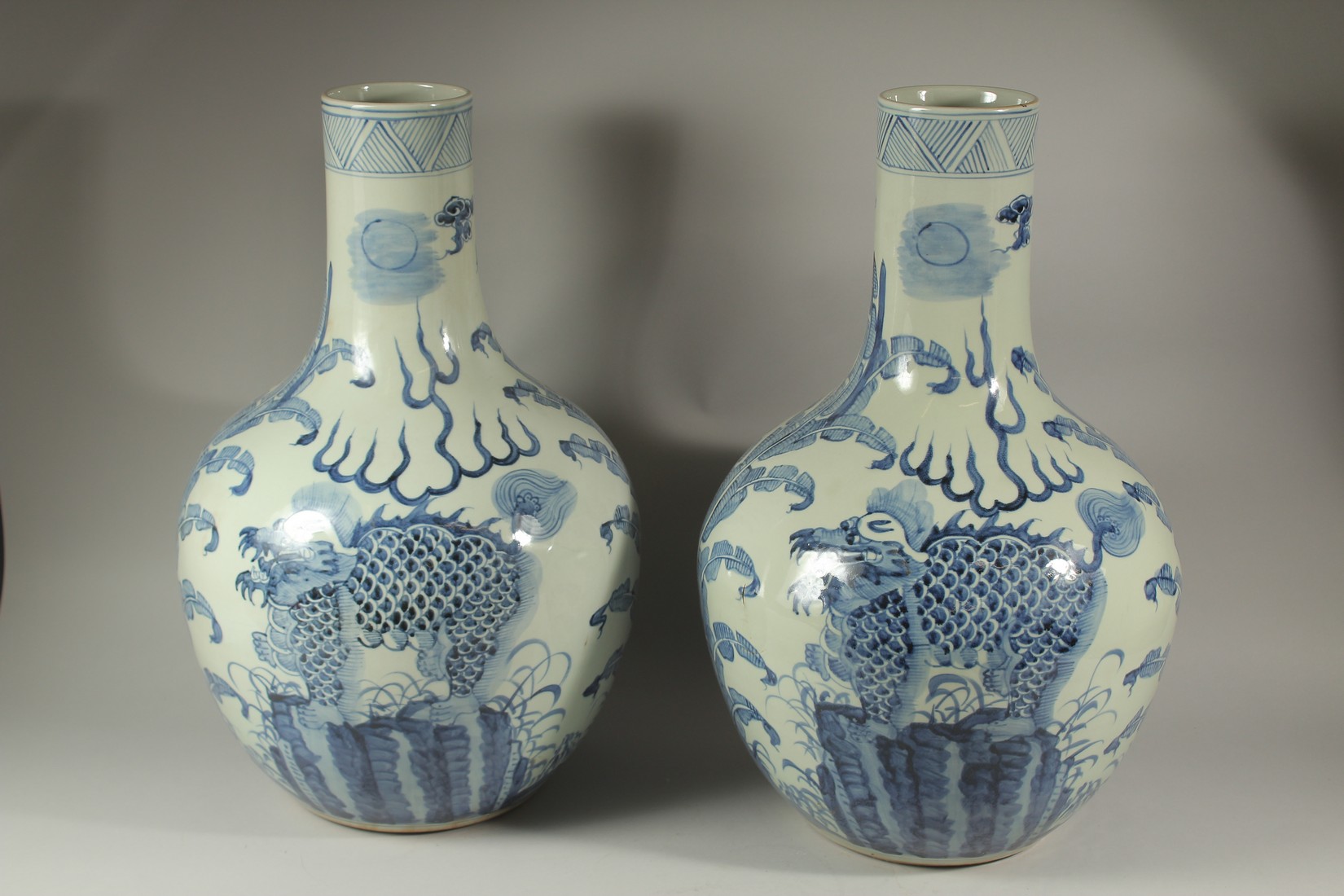 A LARGE PAIR OF CHINESE BLUE AND WHITE BULBOUS VASES decorated with dragons. 60cms high. - Image 4 of 4