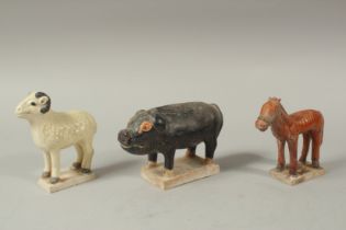 THREE CHINESE TOMB SACRIFICE POTTERY ANIMALS, PIG, HORSE AND SHEEP. Possibly Han Dynasty. 16cms,