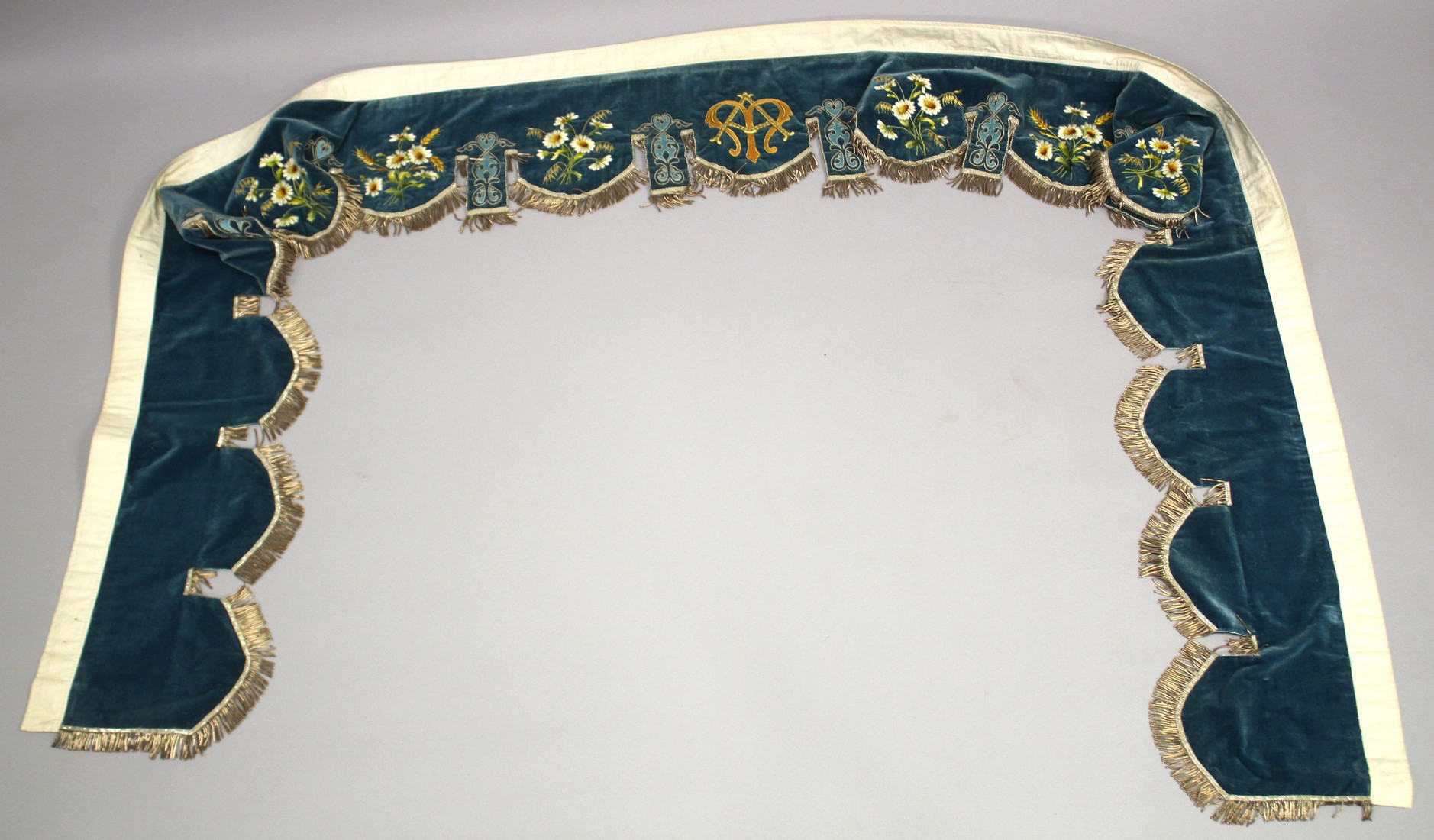 A FINELY EMBROIDERED BLUE VELVET BED HANGING.