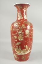A LARGE CHINESE RED GLAZE PORCELAIN VASE, decorated with figures on a boat as well as pagodas and