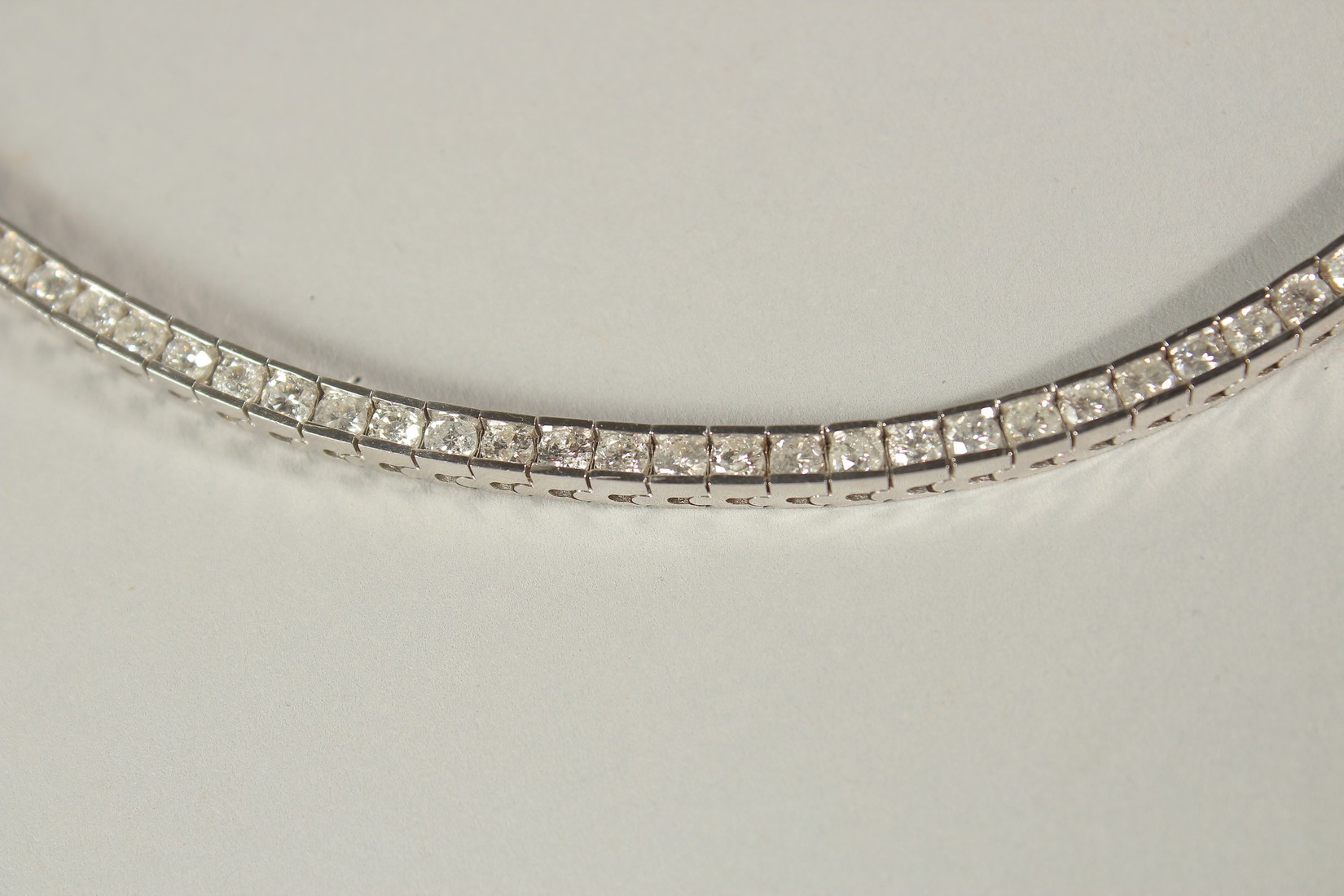 A 14CT WHITE GOLD SEMI-RUBOVER SET RBC DIAMOND LINE BRACELET, with an open blox clasp and safety - Image 5 of 8