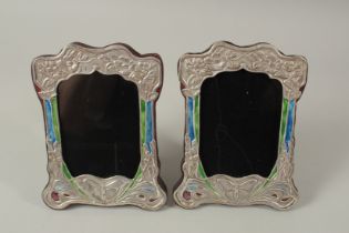 A PAIR OF SILVER AND ENAMEL PHOTOGRAPH FRAMES. 20 x 15cms.