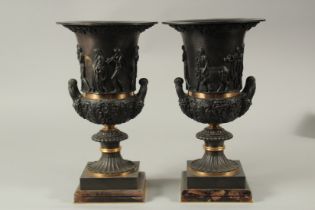 A VERY GOOD PAIR OF CLASSICAL BRONZE TWO HANDLED URNS on square bases. 36cms high.