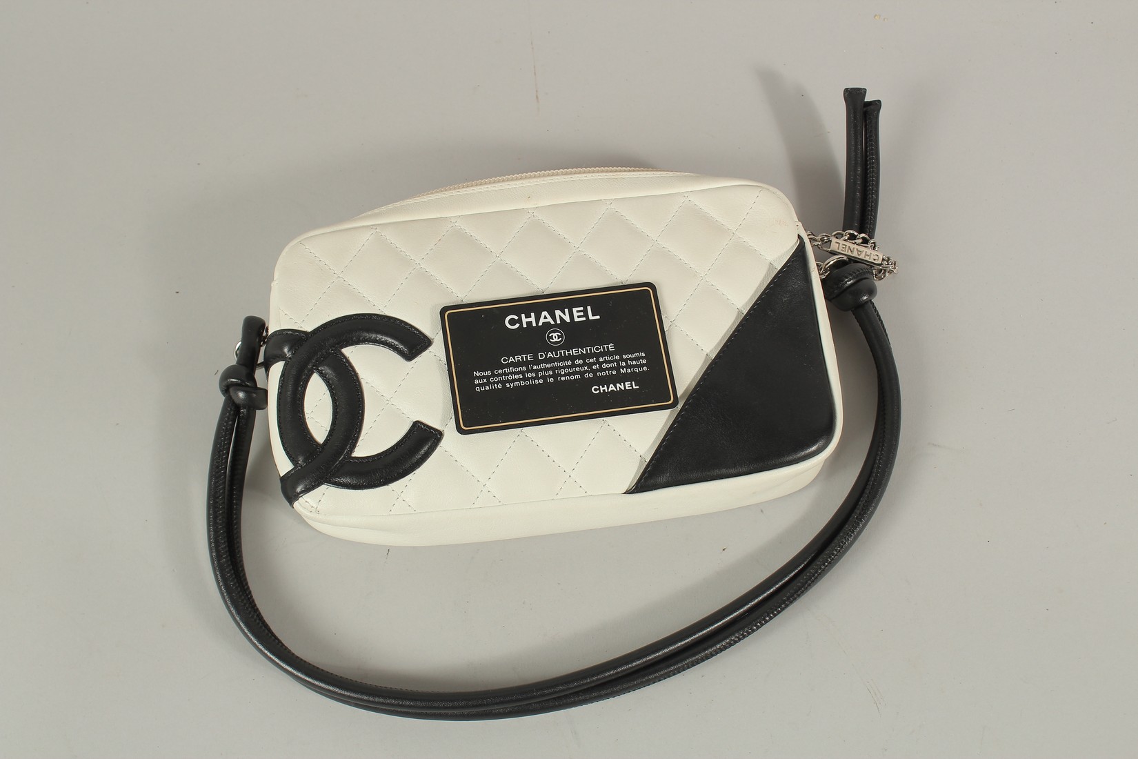 A CHANEL WHITE LEATHER BAG with black CC and handle, with dust cover. 22cms long x 15cms deep. - Image 4 of 6