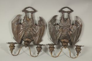 A PAIR OF BRONZE BAT SCONCES with double scrolling branches. 33cms long.