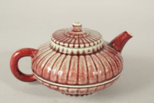 A CHINESE RED GLAZE PORCELAIN TEAPOT, the base with a character mark.