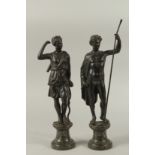 GRAND TOUR BRONZES. A VERY GOOD PAIR OF CLASSICAL BRONZE FIGURES of a man carrying a staff and a