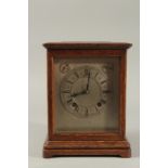 A 1920'S OAK BRACKET CLOCK with silvered dial, silent and chime action, with glass panel sides.