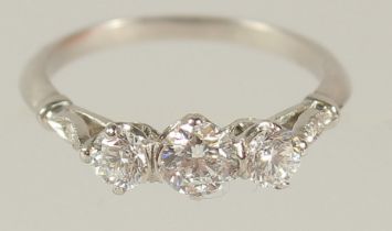 A PLATINUM THREE STONE DIAMOND RING.