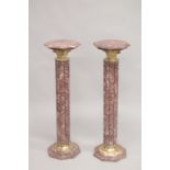 A PAIR OF VEINED RED MARBLE CLUSTER COLUMNS with octagonal tops and bases. 3ft 4ins high.