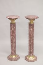 A PAIR OF VEINED RED MARBLE CLUSTER COLUMNS with octagonal tops and bases. 3ft 4ins high.
