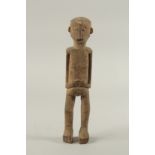 A CARVED WOOD TRIBAL FIGURE. 14ins high.