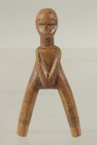 A CARVED WOOD TRIBAL CATAPAULT formed as a man. 7ins high.