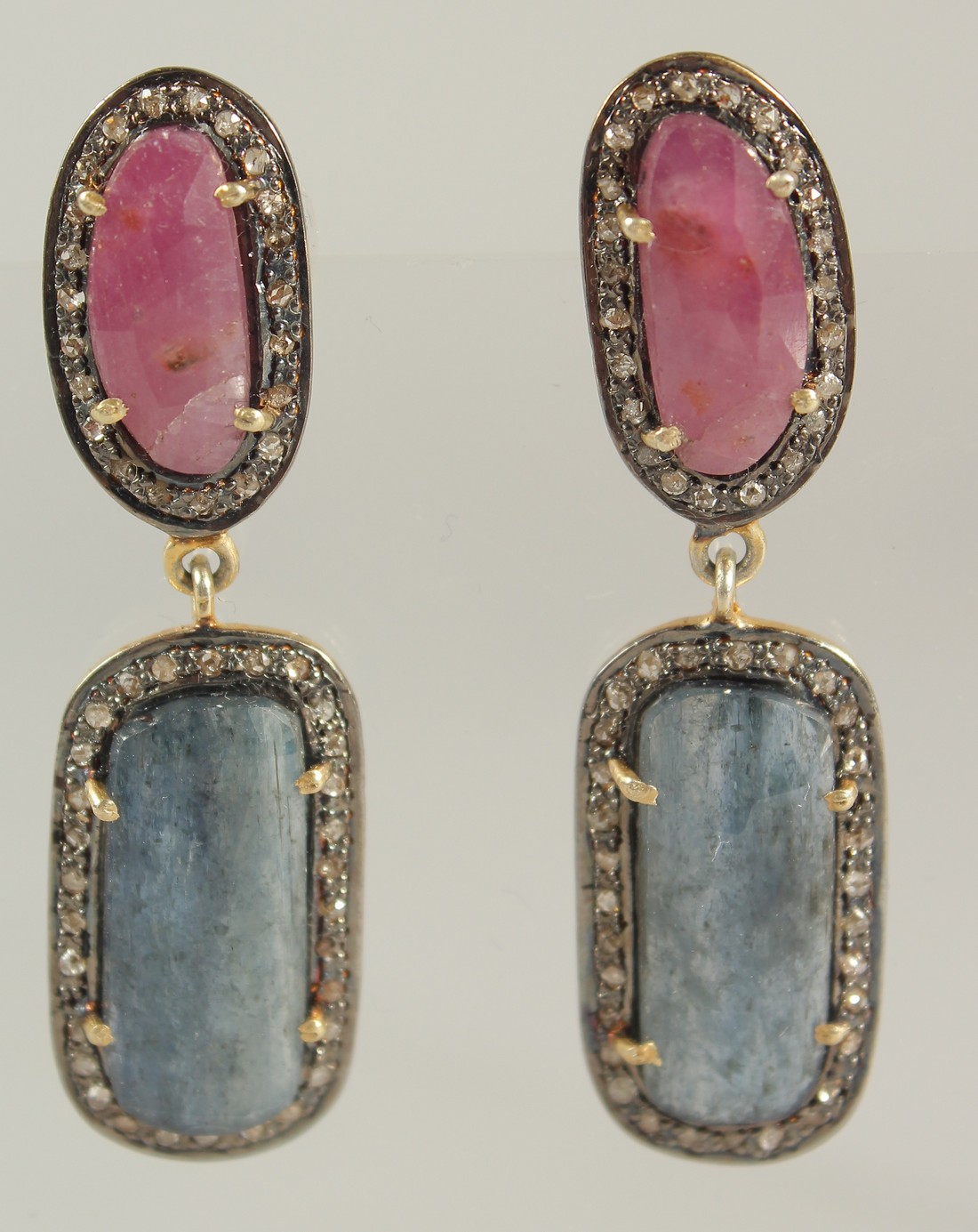 A LARGE ARTICULATED PAIR OF MIXED ROSE-CUT RED AND BLUE SAPPHIRE DROP EARRINGS IN SILVER GILT,