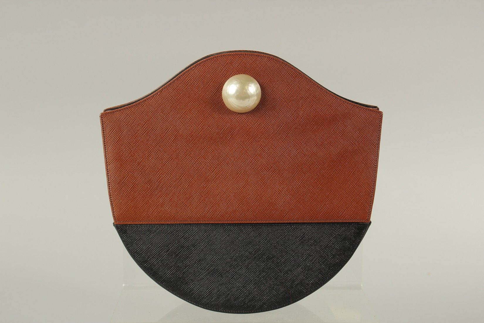 A RENAUD PELLEGRINO, PARIS, BLACK AND BROWN BAG with mother-of-pearl stud. 21cms long x 20cms deep.