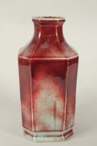 A CHINESE RED GLAZE FLAMBE-TYPE PORCELAIN OCTAGONAL VASE, with character mark to the base. 32.5cms