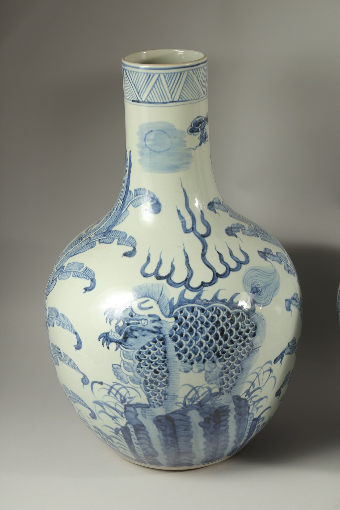 A LARGE PAIR OF CHINESE BLUE AND WHITE BULBOUS VASES decorated with dragons. 60cms high. - Image 2 of 4