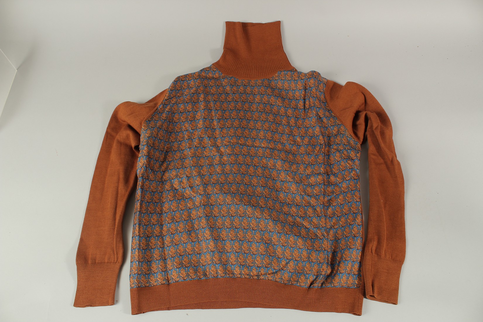 A HERMES TAN AND BLUE, SILK AND WOOL, POLO NECK LONG SLEEVED SWEATER.