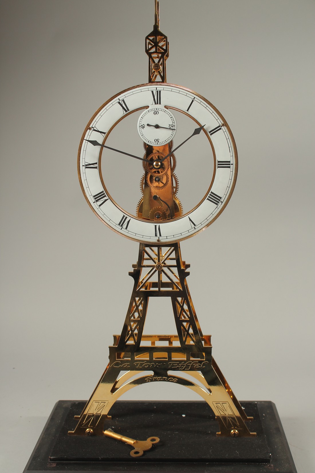 AN EIFFEL TOWER BRASS SKELETON CLOCK in a glass case. 56cms high. - Image 2 of 4