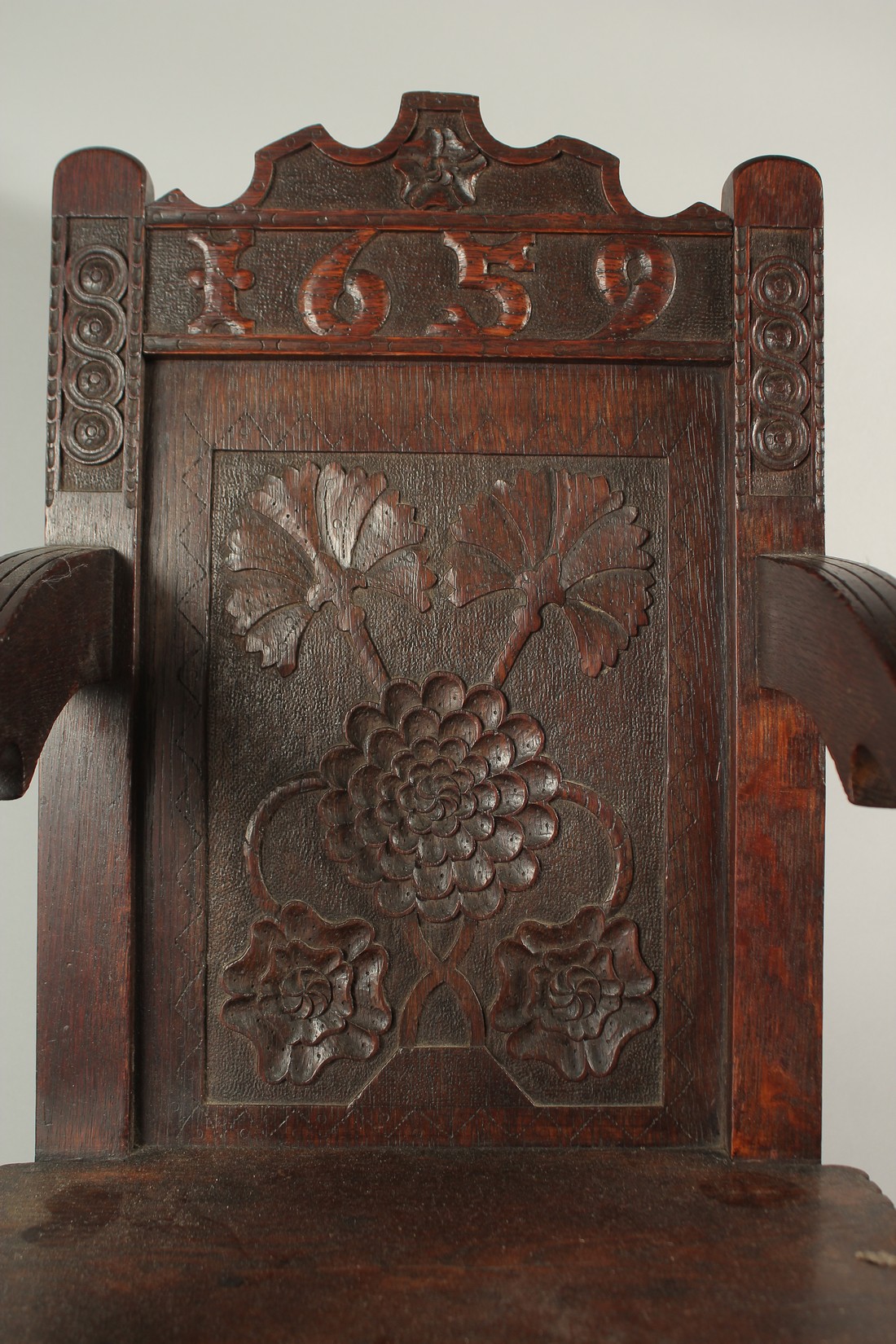 A CHILD'S 17TH CENTURY HIGH CHAIR, dated 1659, with carved back and solid seat. 3ft 6ins high x - Image 2 of 4