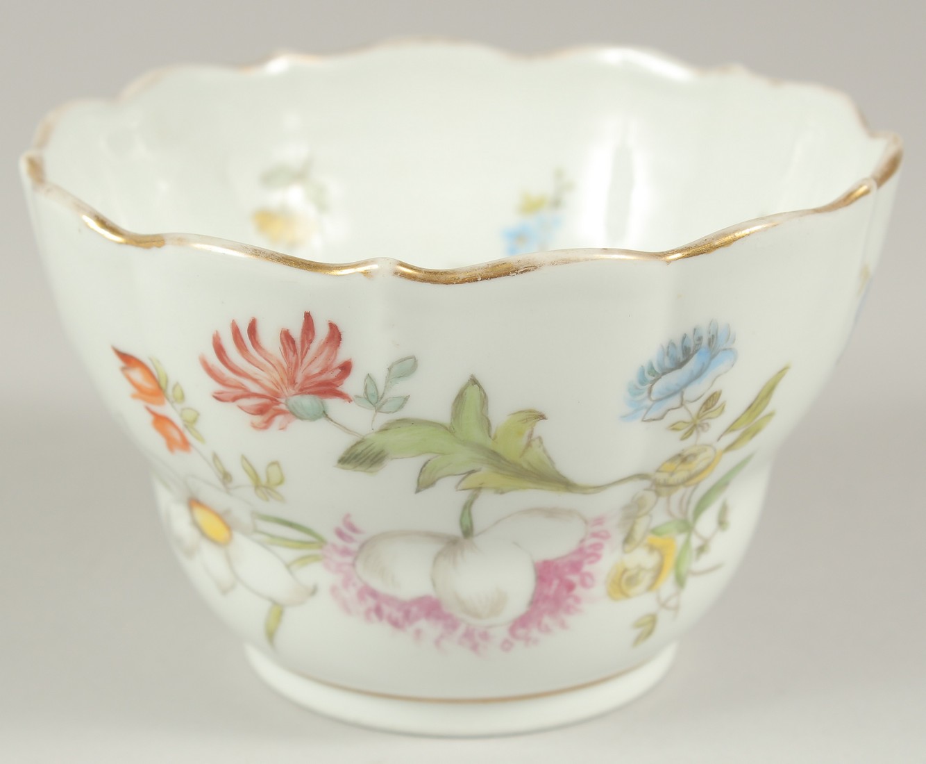 A MEISSEN PORCELAIN CIRCULAR BOWL, white ground and painted with flowers. 4.5ins diameter. Cross