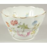 A MEISSEN PORCELAIN CIRCULAR BOWL, white ground and painted with flowers. 4.5ins diameter. Cross