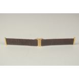 A BOUCHERON BROWN STRAP in a Boucheron case. 17cms long.