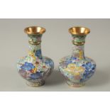 A SMALL PAIR OF BLUE CLOISONNE ENAMEL VASES. 12cms high.