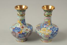 A SMALL PAIR OF BLUE CLOISONNE ENAMEL VASES. 12cms high.