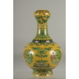 A CHINESE YELLOW GROUND PORCELAIN 'GARLIC HEAD' VASE, with character mark to base. 24cm high.