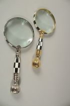 A PAIR OF GILT MAGNIFYING GLASSES with black and white chequered handles.